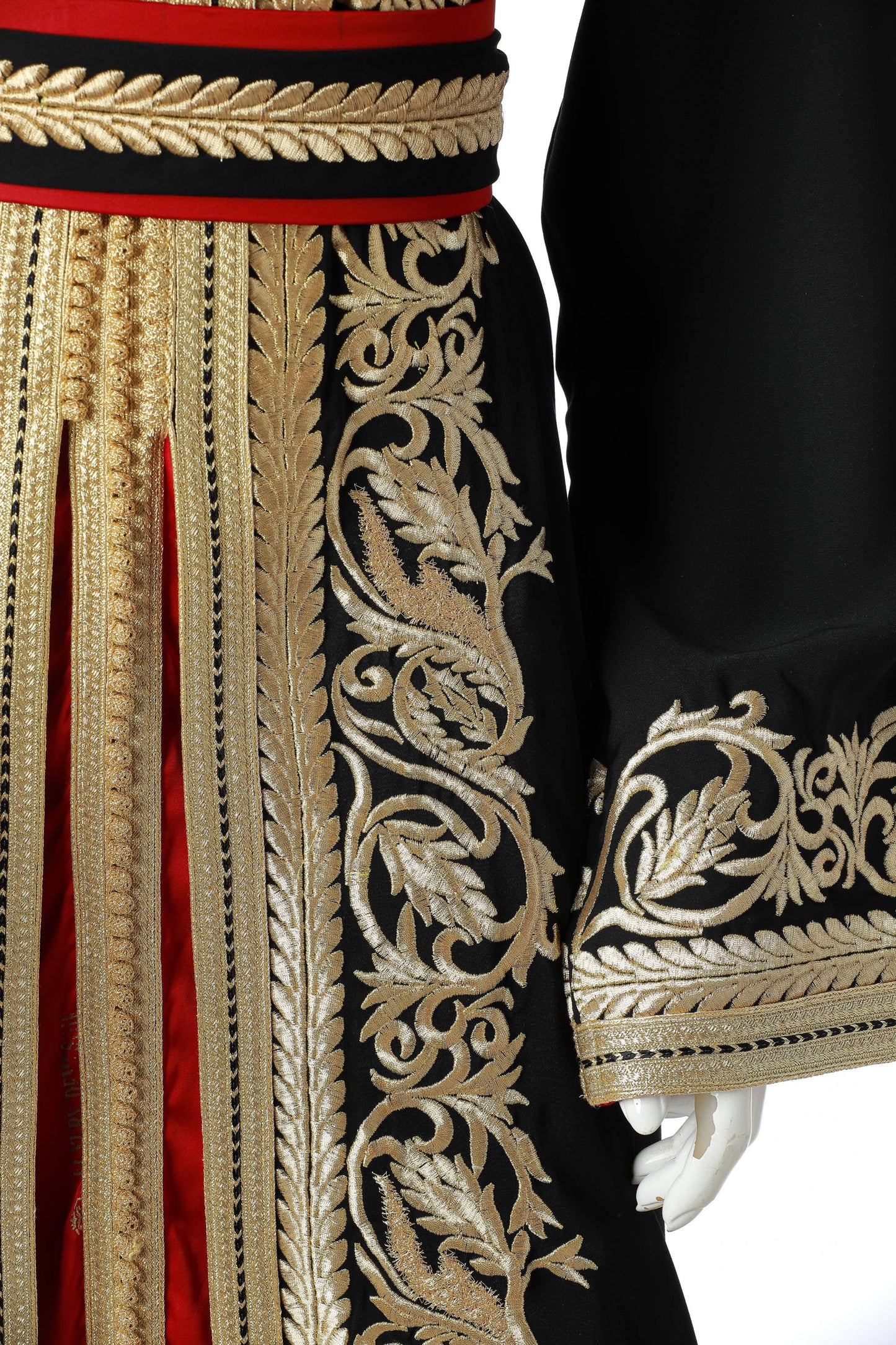 Detailed Yaqut Marrakesh Moroccan Kaftan in Black Silk Crepe with Gold Embroidery and Crimson Under-Kaftan – Luxury Women’s Dress Highlighting Sleeve, Waist, and Flowing Skirt Design | قفطان مغربي مفصل ياقوت مراكش من حرير كريب أسود بتطريز ذهبي وقفطان داخلي قرمزي – فستان نسائي فاخر يبرز تفاصيل الأكمام والخصر وتنورة متدفقة