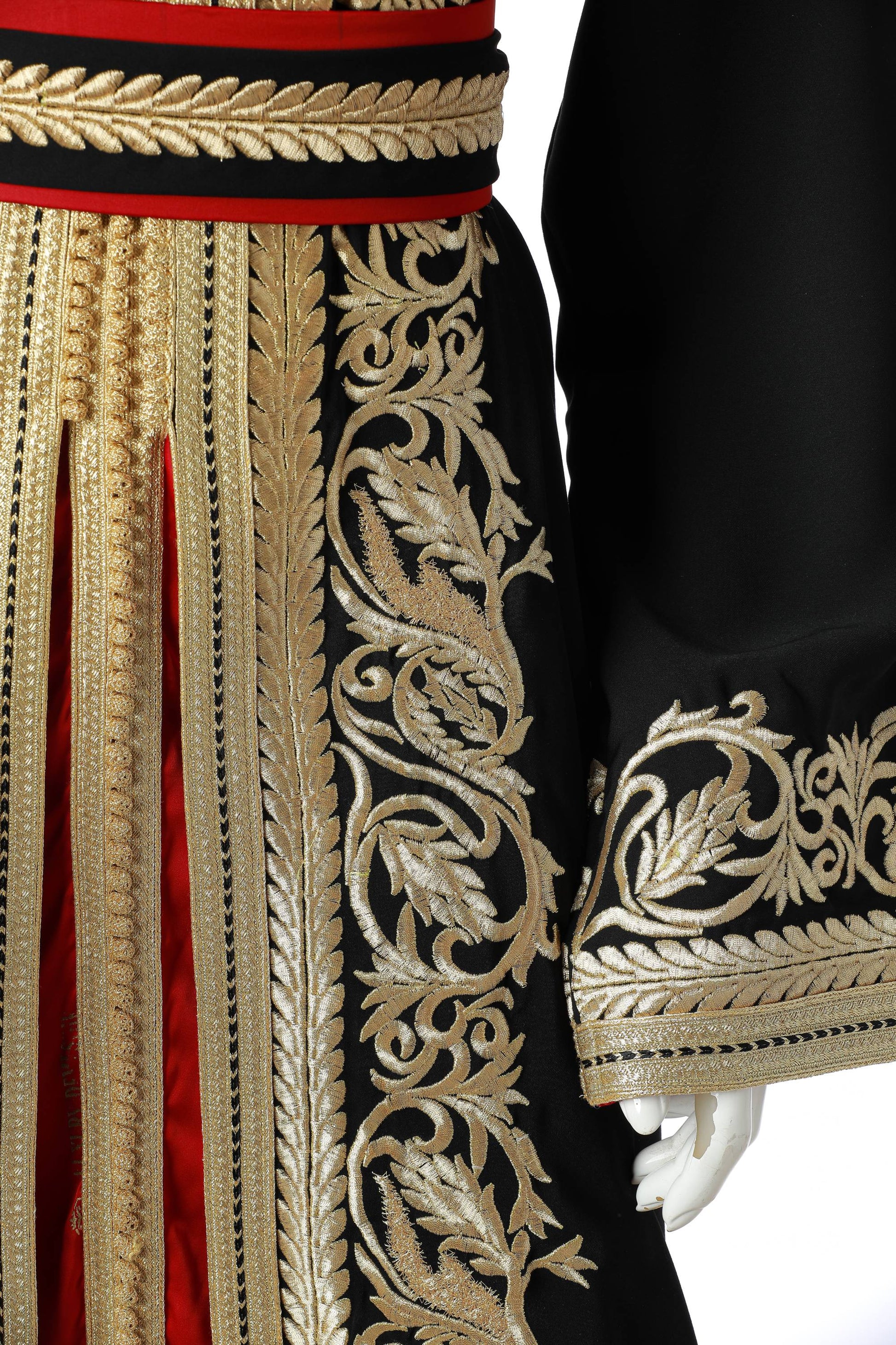 Detailed Yaqut Marrakesh Moroccan Kaftan in Black Silk Crepe with Gold Embroidery and Crimson Under-Kaftan – Luxury Women’s Dress Highlighting Sleeve, Waist, and Flowing Skirt Design | قفطان مغربي مفصل ياقوت مراكش من حرير كريب أسود بتطريز ذهبي وقفطان داخلي قرمزي – فستان نسائي فاخر يبرز تفاصيل الأكمام والخصر وتنورة متدفقة